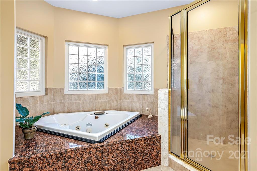 5628 Plantation Ridge Road Charlotte, NC 28214 - Photo 19 of 43 a bathroom with a tub and shower
