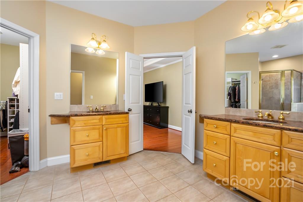 5628 Plantation Ridge Road Charlotte, NC 28214 - Photo 20 of 43 a spacious bathroom with a granite countertop sink and a mirror