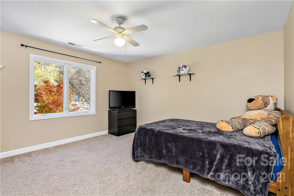5628 Plantation Ridge Road Charlotte, NC 28214 - Photo 24 of 43 a bedroom with a bed and a tv