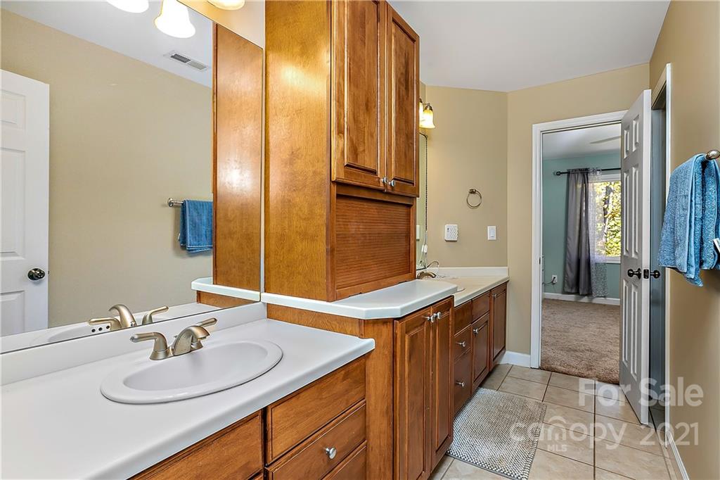 5628 Plantation Ridge Road Charlotte, NC 28214 - Photo 25 of 43 a bathroom with a sink and a mirror