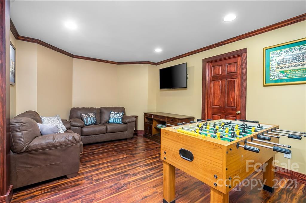 5628 Plantation Ridge Road Charlotte, NC 28214 - Photo 34 of 43 a living room with furniture and a wooden floor