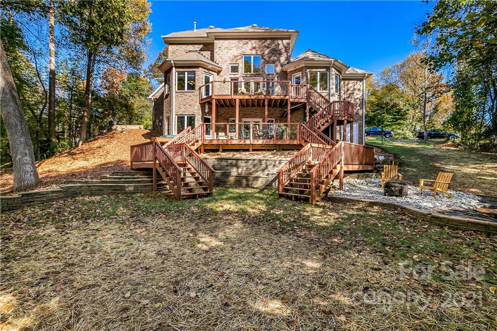 5628 Plantation Ridge Road Charlotte, NC 28214 - Photo 41 of 43 a view of a large white house with a yard and lawn chairs