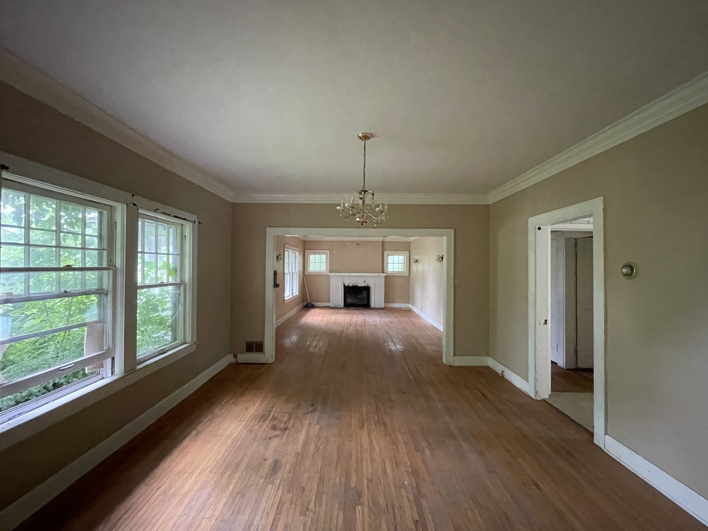 840 East Lincoln Street Hoopeston, IL 60942 - Photo 9 of 33 a view of empty room with wooden floor and fireplace
