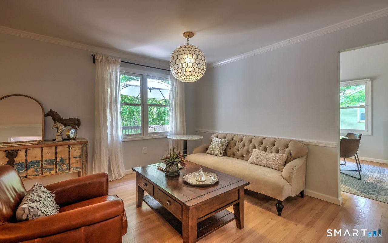 9 Canterbury Road, Unit 9 Hamden, CT 06514 - Photo 11 of 29 a living room with furniture a table and a window