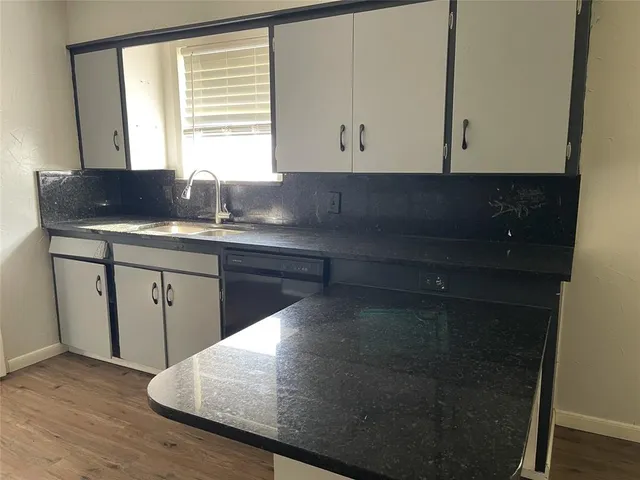 a kitchen with a sink and cabinets