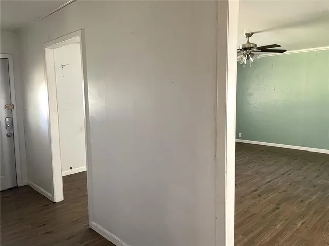 an empty room with wooden floor