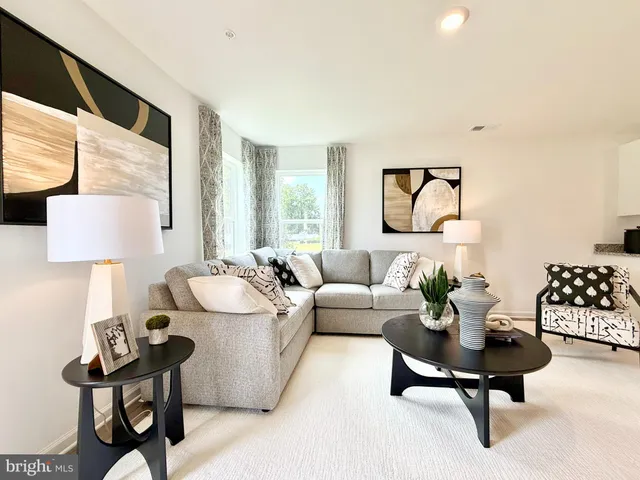 a living room with furniture and a lamp