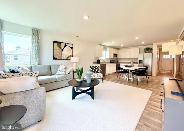 a living room with furniture and kitchen view