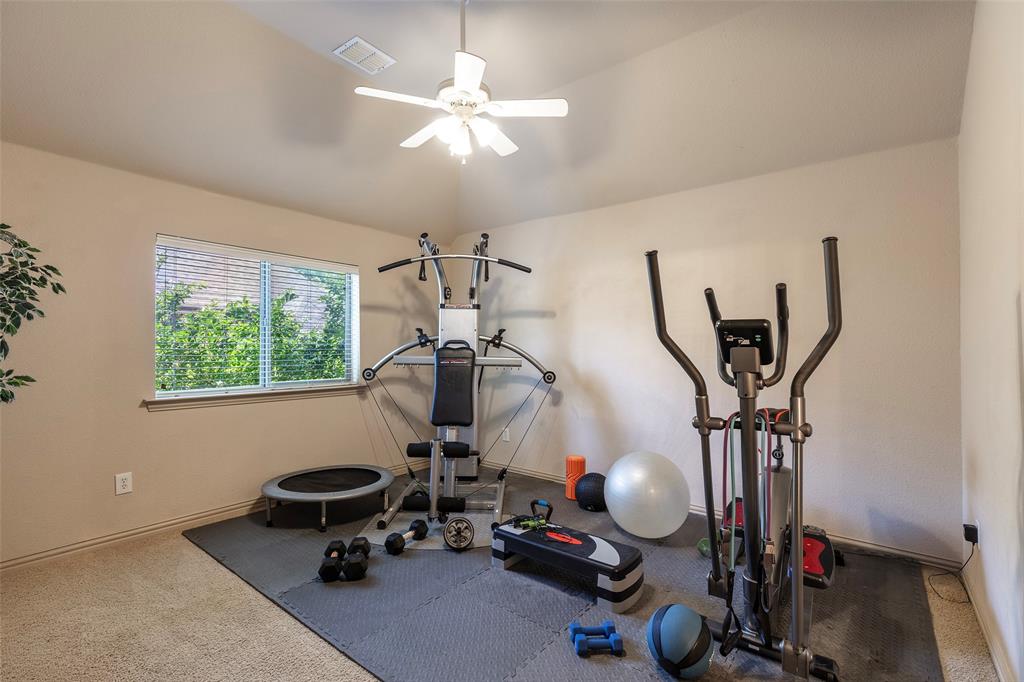 1217 Windmere Way Allen, TX 75013 - Photo 32 of 38 Currently styled as a private home fitness space, this flexible upstairs bedroom easily transitions into a guest suite, playroom, or additional office with direct access to the Jack and Jill bath.