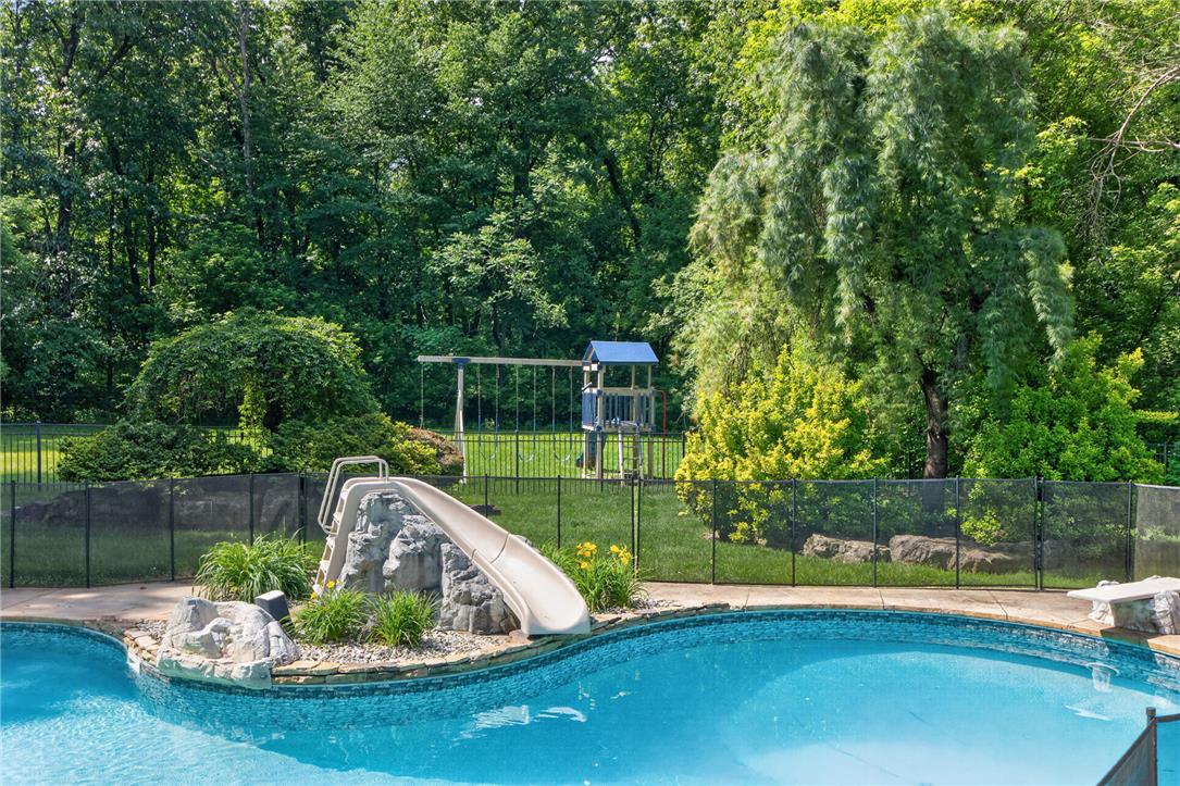 1371 Stoke Park Road Bethlehem, PA 18017 - Photo 9 of 55 a view of a swimming pool with a patio and a garden