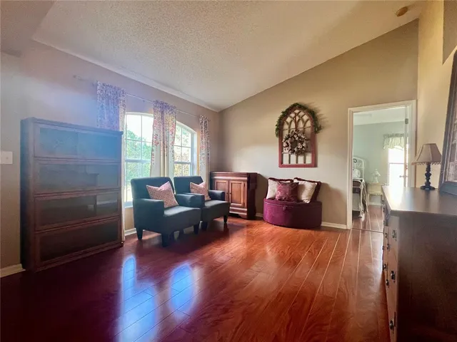 a living room with furniture window and wooden floor