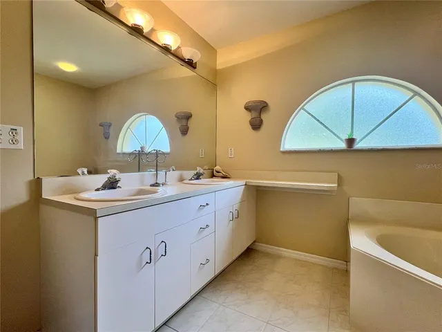 a bathroom with a double vanity sink and a mirror