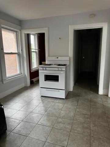 a kitchen with a stove a sink and a cabinets