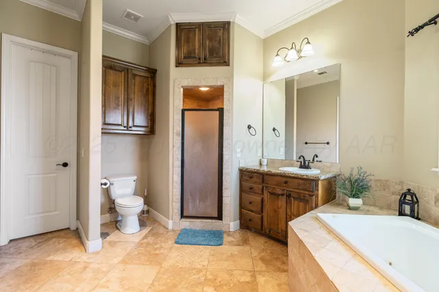 a spacious bathroom with a tub sink and mirror