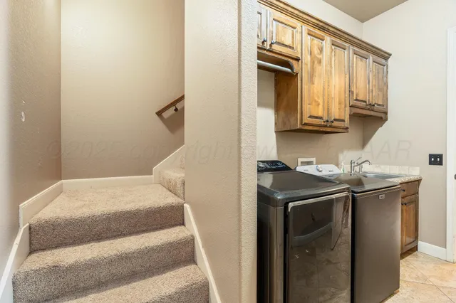 a utility room with a sink washer and dryer