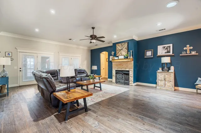 a living room with furniture a fireplace and a flat screen tv