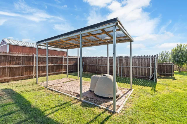 a view of backyard with swimming pool and green space