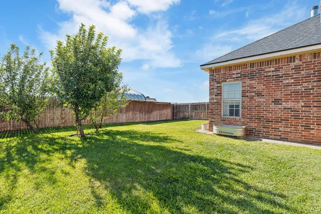 a view of a backyard with sitting area