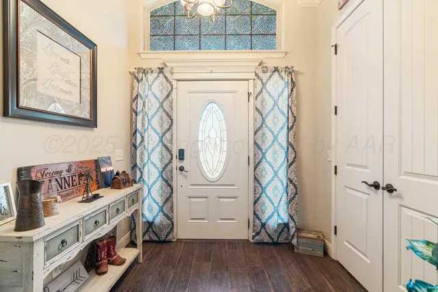 a view of an entryway with wooden floor