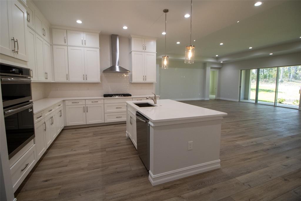 3970 Southern Valley Loop Brooksville, FL 34601 - Photo 16 of 55 a kitchen with a sink window and cabinets