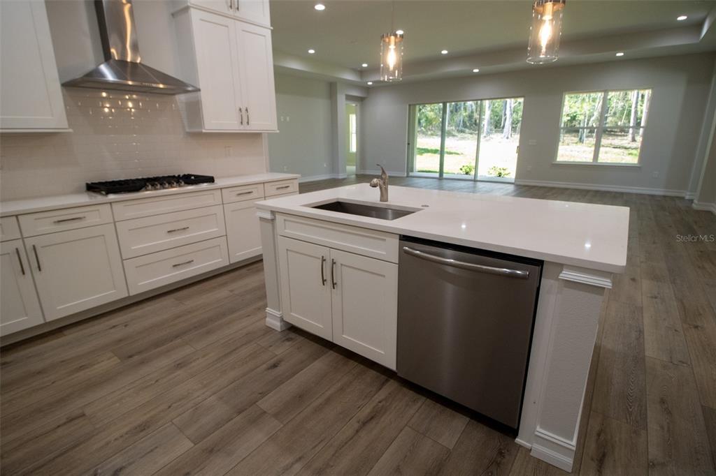 3970 Southern Valley Loop Brooksville, FL 34601 - Photo 18 of 55 a kitchen with white cabinets sink and window