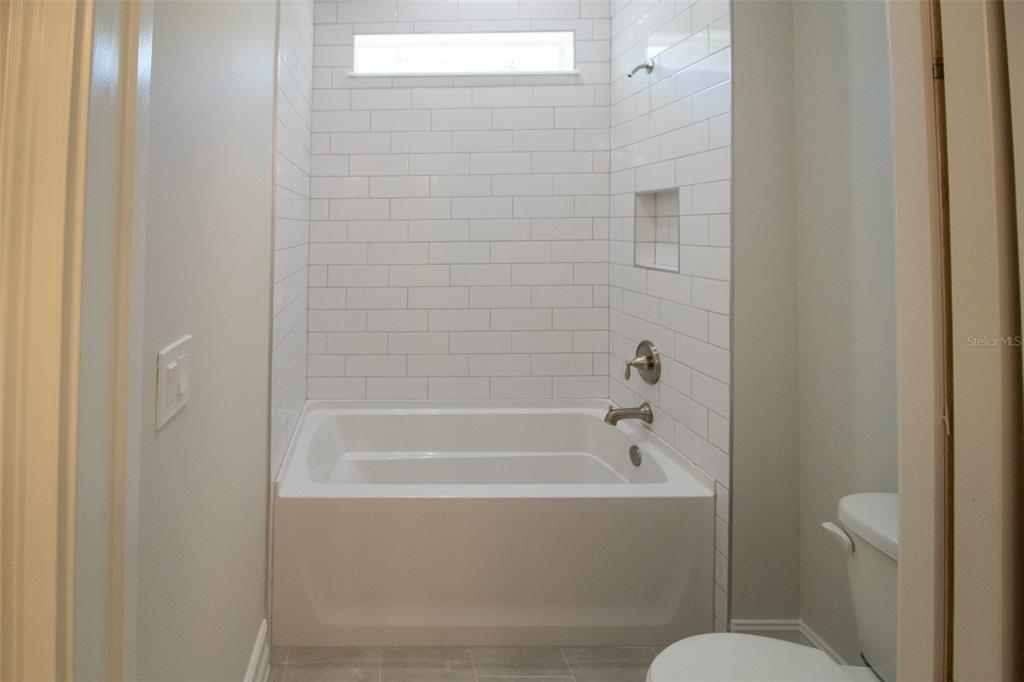 3970 Southern Valley Loop Brooksville, FL 34601 - Photo 34 of 55 a bathroom with sink mirror and toilet