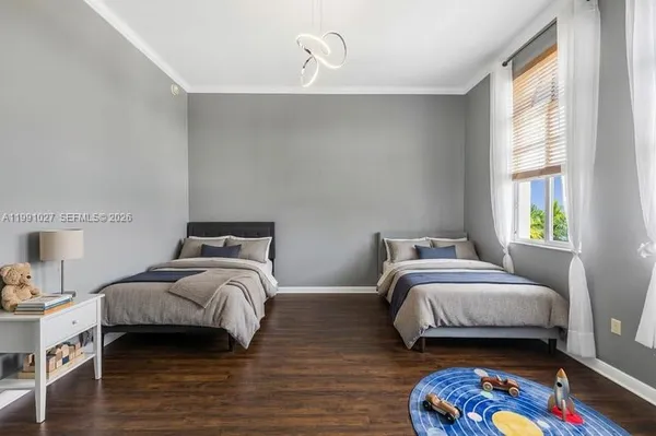a bedroom with two bed and a window