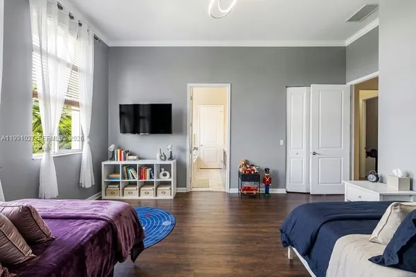 a living room with a bed furniture and a flat screen tv
