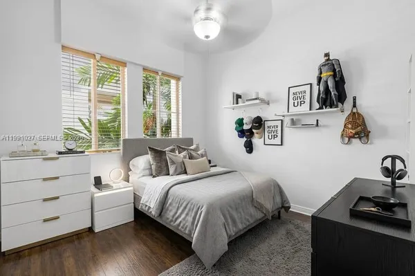 a bedroom with a bed and a large window