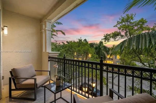 a view of a two chairs in the balcony