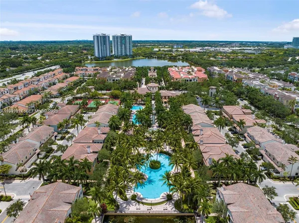 an aerial view of residential houses with outdoor space and street view