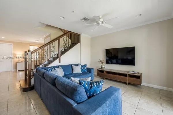 a living room with furniture and a flat screen tv