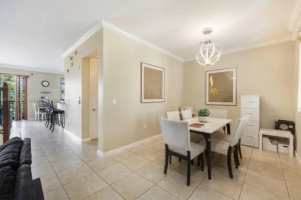 a view of a dining room with furniture and chandelier