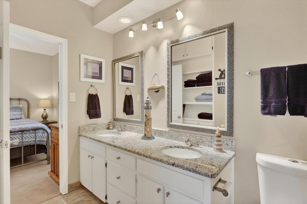 8877 Random Road Fort Worth, TX 76179 - Photo 24 of 40 a bathroom with a granite countertop sink and a mirror