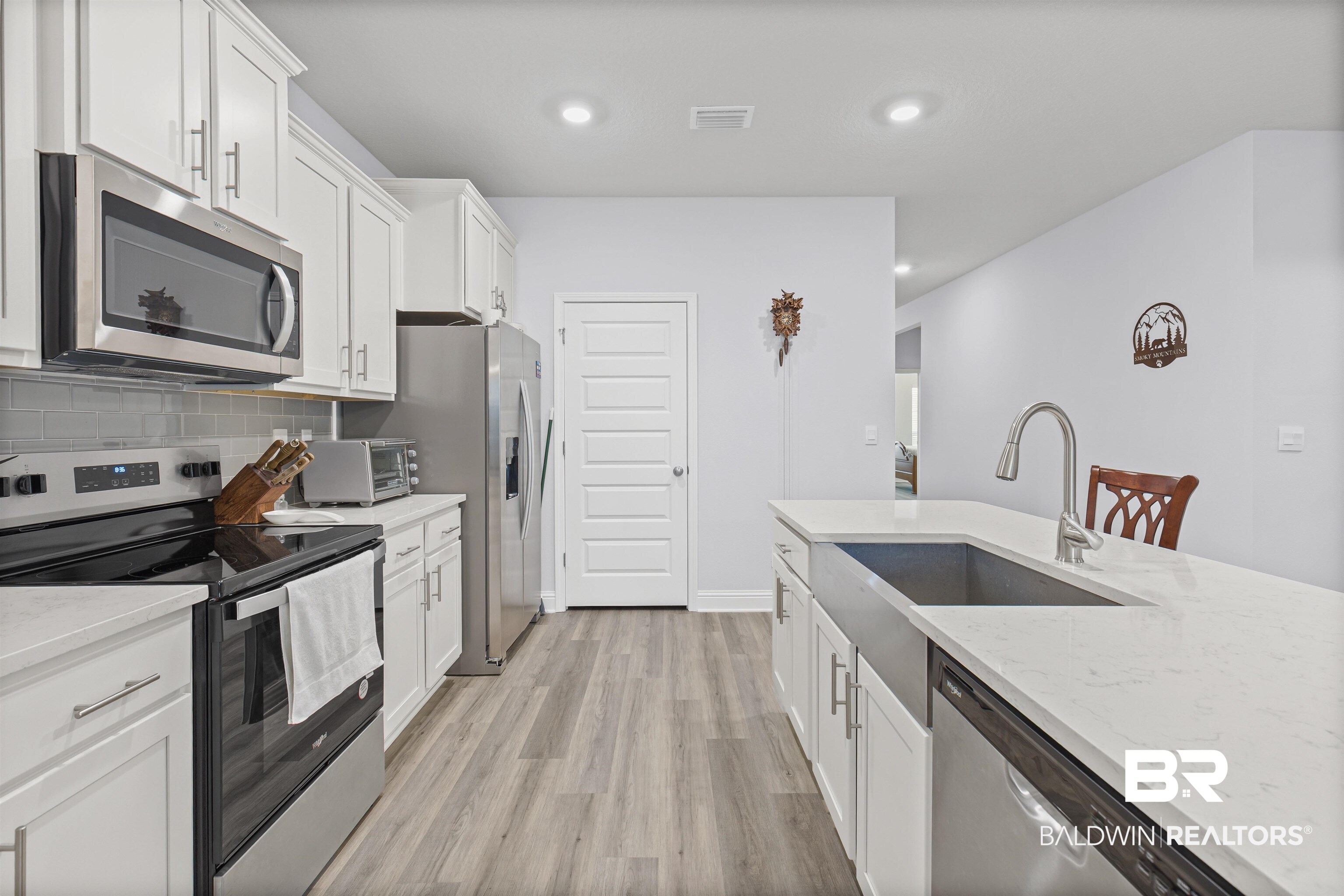 10564 Heirloom Road South Mobile, AL 36608 - Photo 10 of 24 Kitchen with stainless steel appliances, light stone countertops, white cabinetry, and recessed lighting