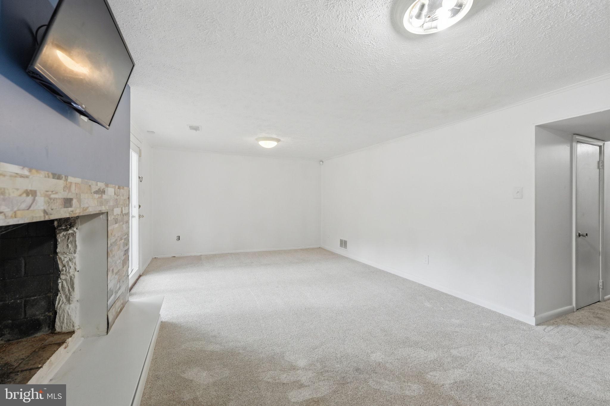 8260 Getty Court Springfield, VA 22153 - Photo 26 of 31 a view of an empty room with a fireplace