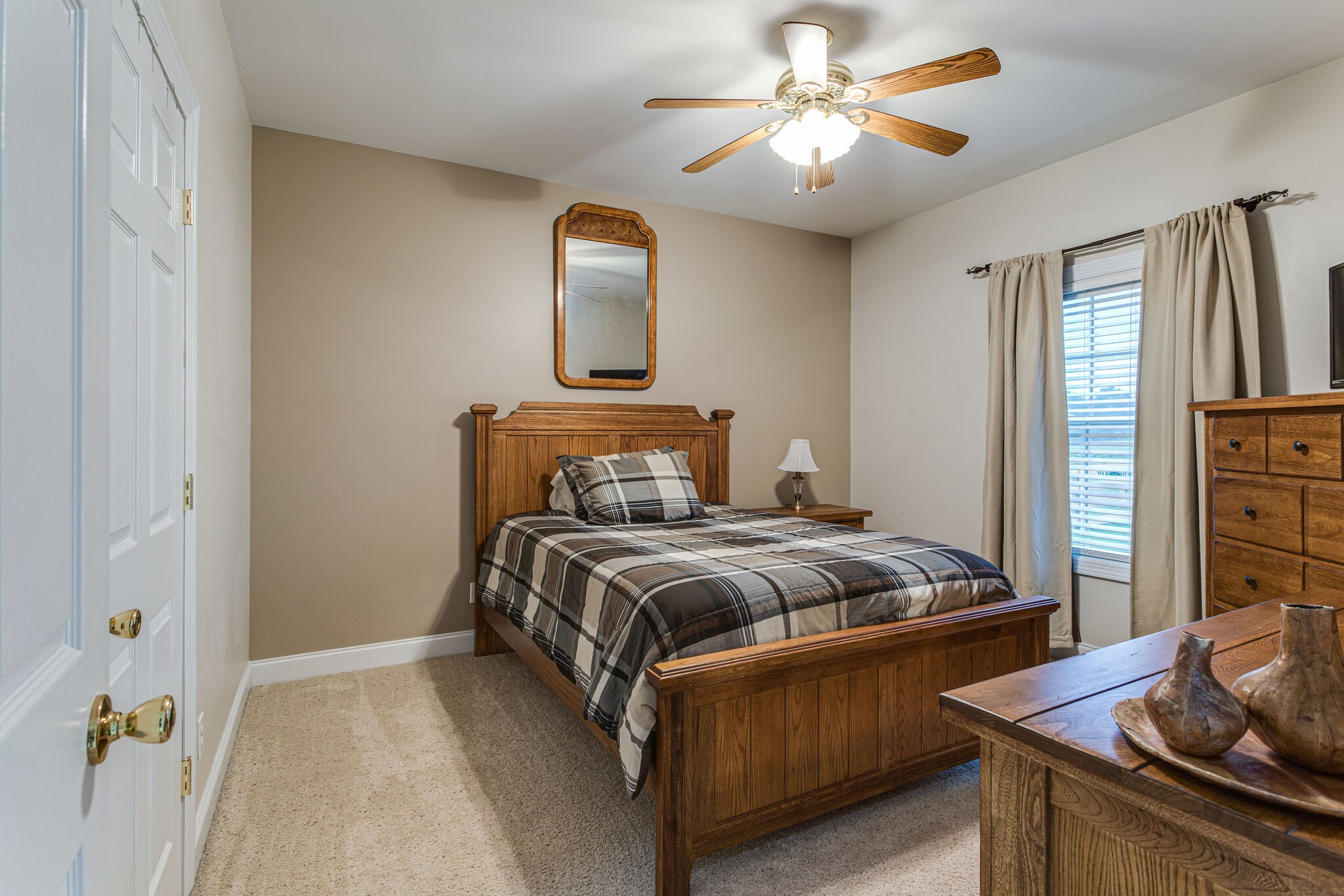 481 Matts Hollow Road Manchester, TN 37355 - Photo 29 of 42 a bedroom with a bed and a chandelier