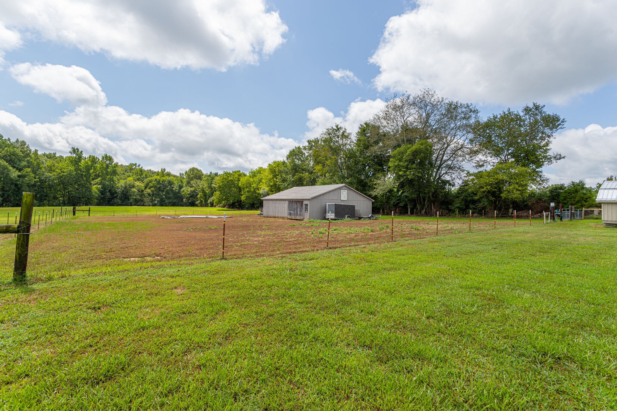481 Matts Hollow Road Manchester, TN 37355 - Photo 41 of 42 a backyard of a house with lots of green space and lake view