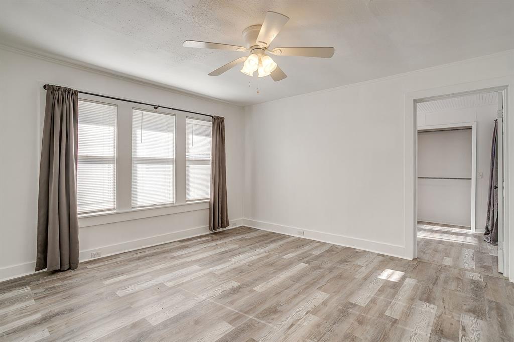 206 Bateman Street Meridian, TX 76665 - Photo 11 of 26 Unfurnished bedroom with light wood-style flooring, a ceiling fan, and ornamental molding
