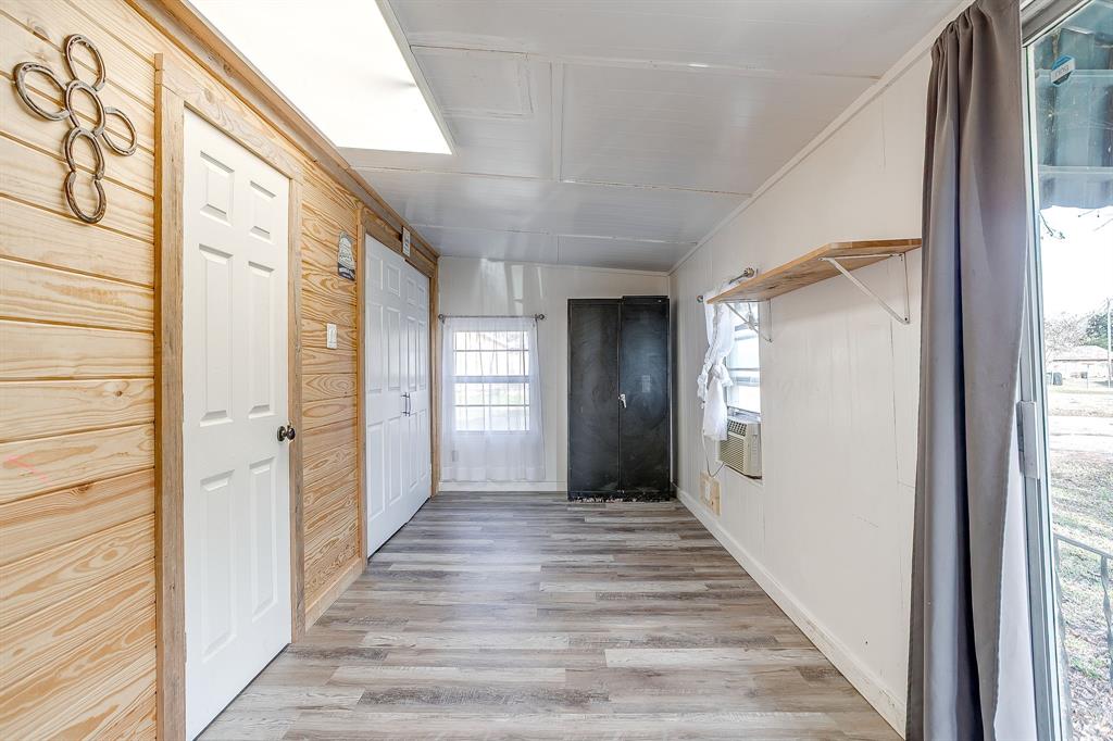206 Bateman Street Meridian, TX 76665 - Photo 18 of 26 Hall featuring light wood-style floors and baseboards