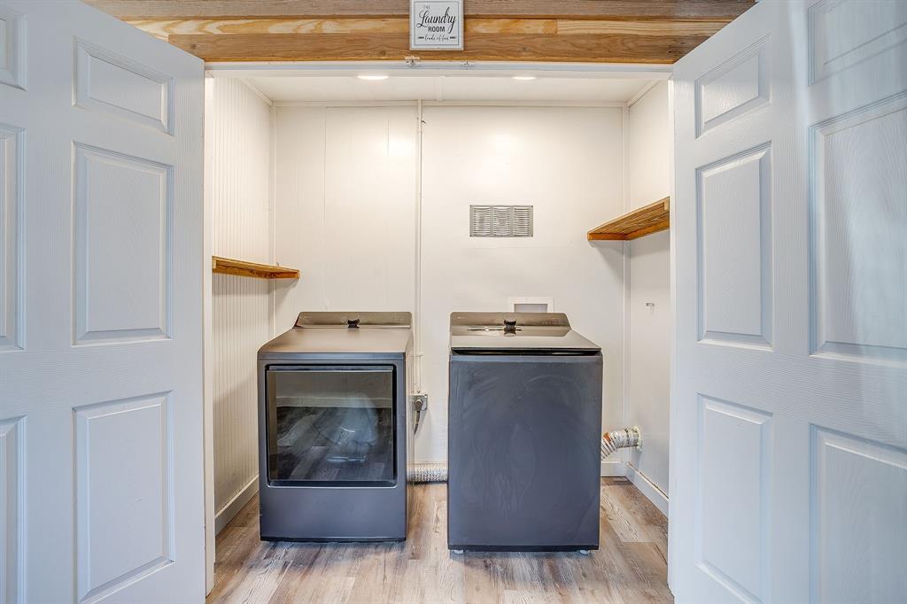 206 Bateman Street Meridian, TX 76665 - Photo 19 of 26 Washroom with light wood-style floors and washer and clothes dryer