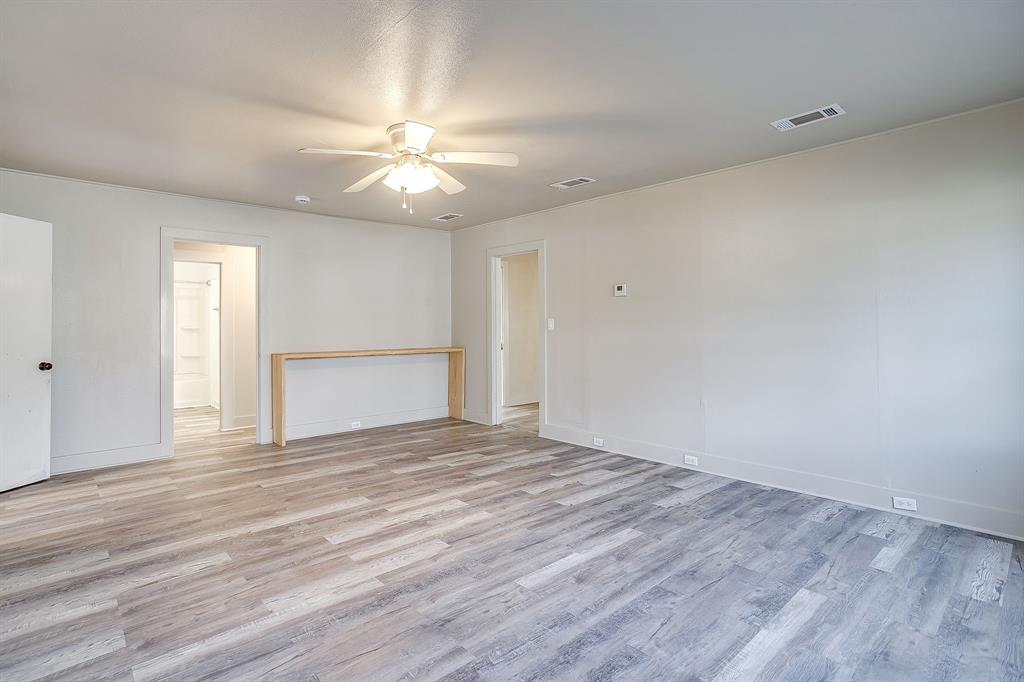 206 Bateman Street Meridian, TX 76665 - Photo 4 of 26 Empty room featuring light wood-style floors and ceiling fan