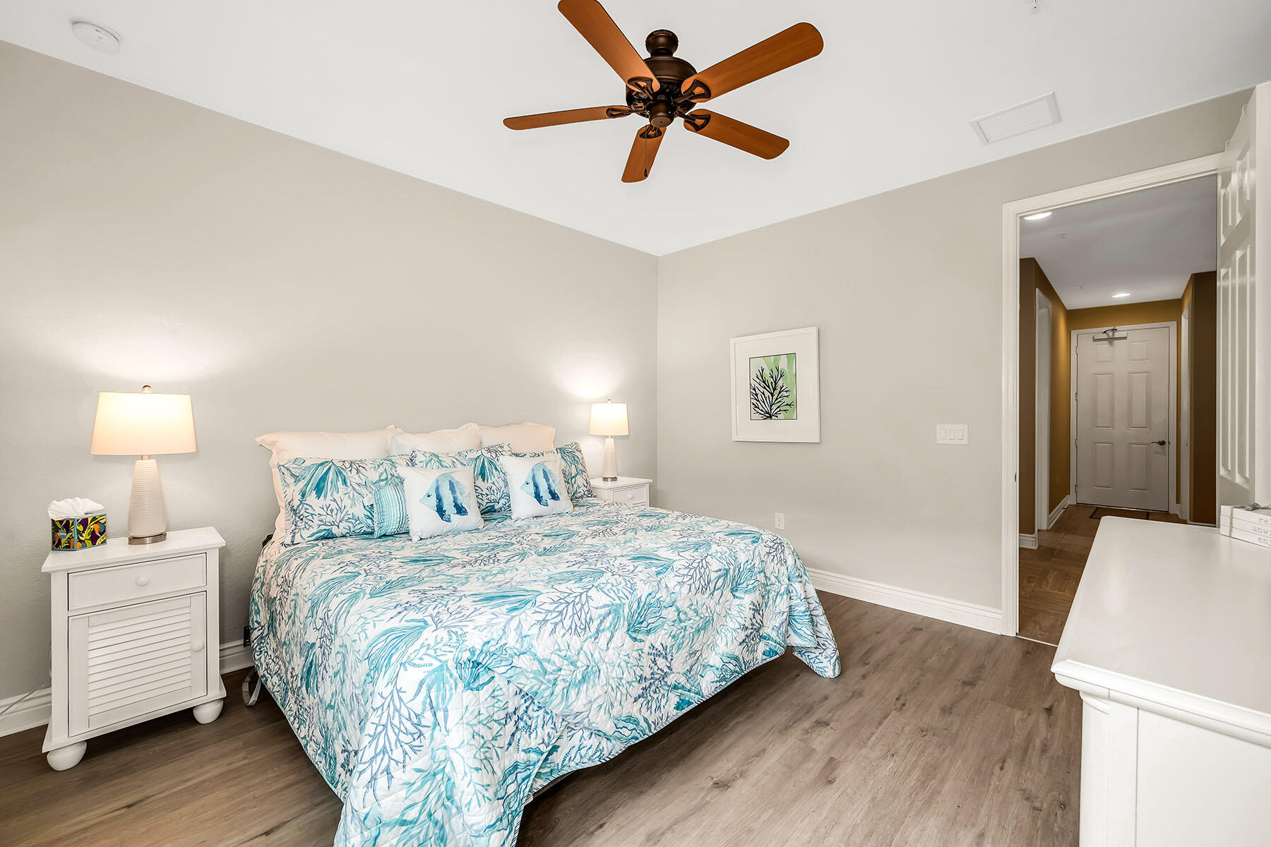 9066 Albion Lane North, Unit 5101 Naples, FL 34113 - Photo 27 of 48 a bedroom with a bed and a lamp on the dresser