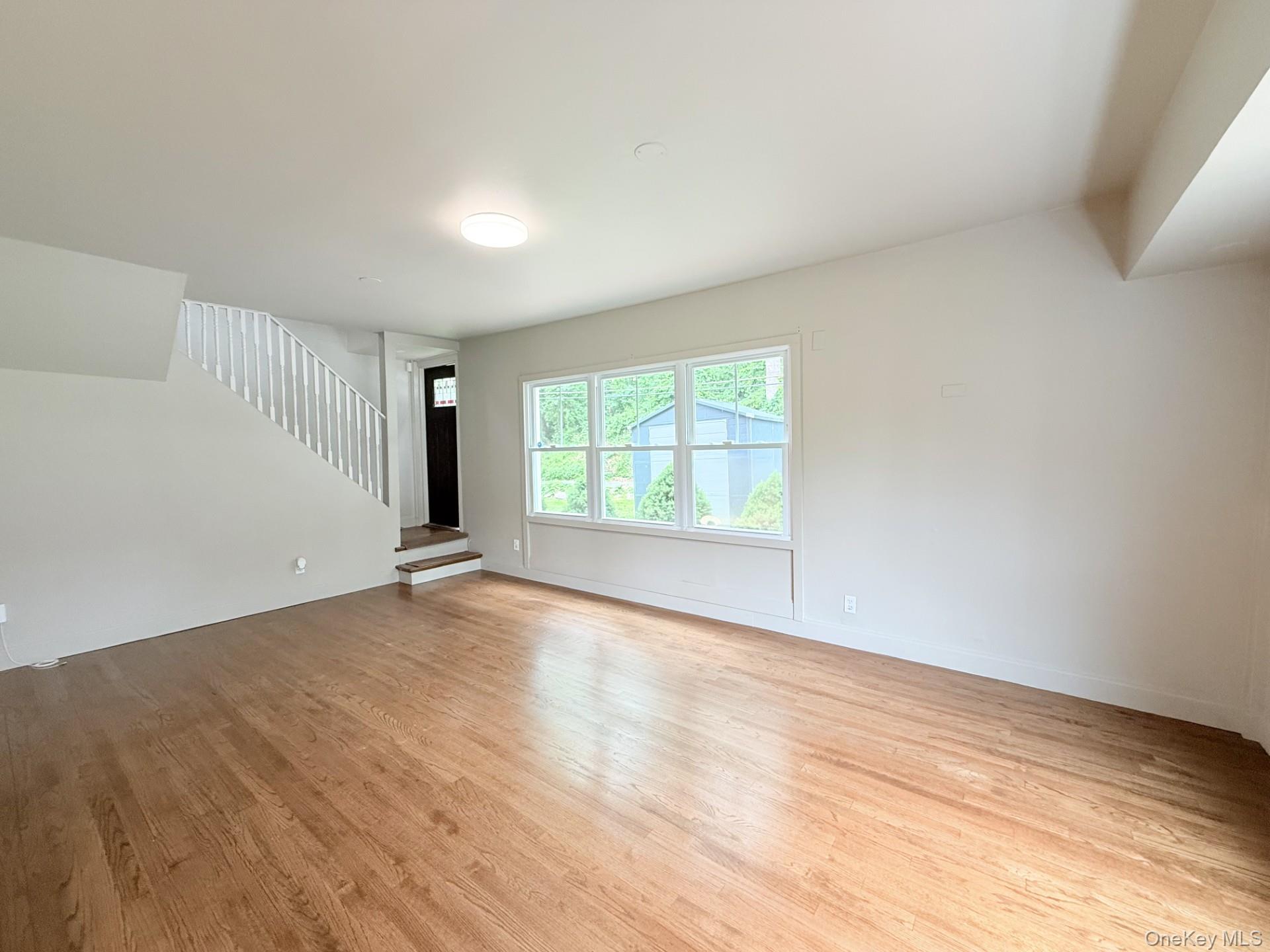 4 Lower Trinity Pass Road Pound Ridge, NY 10576 - Photo 5 of 29 an empty room with wooden floor and windows