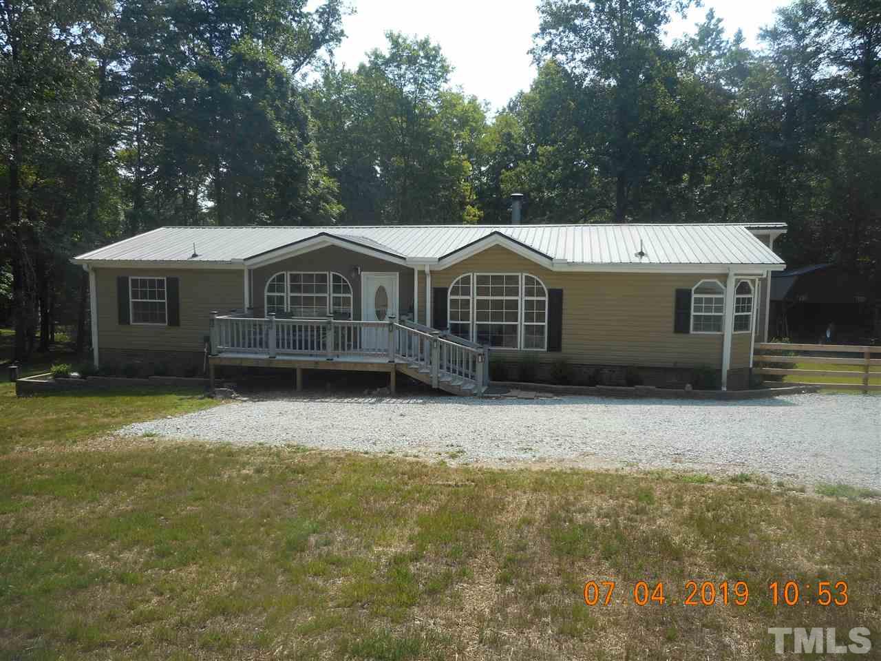 301 Mountain Ridge Road Rougemont, NC 27572 - Photo 2 of 22 a front view of a house with a garden
