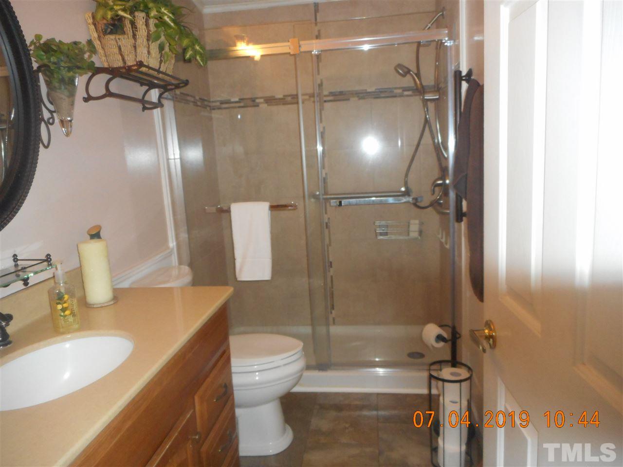 301 Mountain Ridge Road Rougemont, NC 27572 - Photo 13 of 22 a bathroom with a granite countertop sink toilet and shower