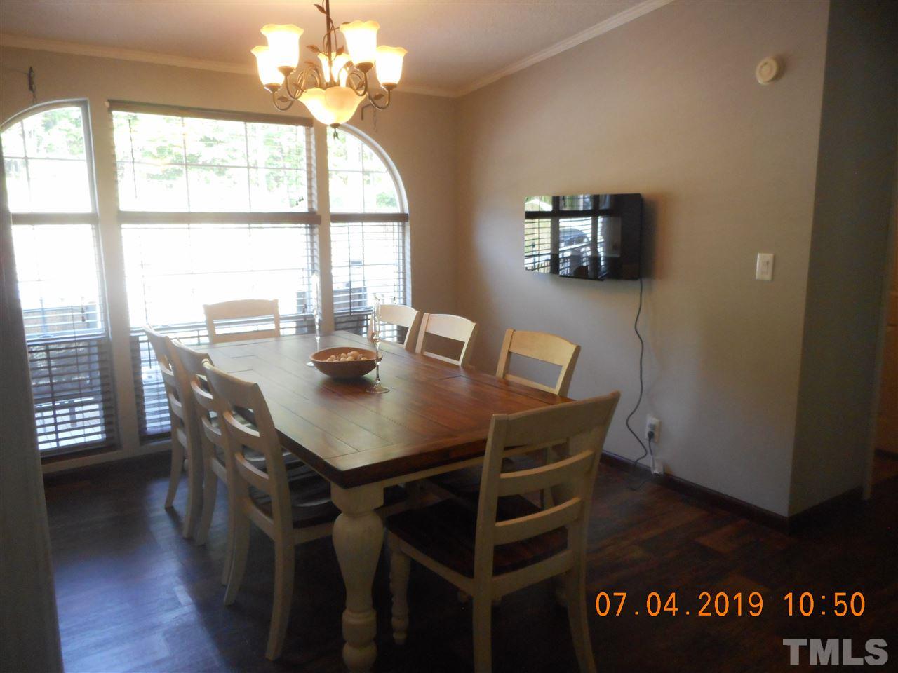 301 Mountain Ridge Road Rougemont, NC 27572 - Photo 14 of 22 a view of a dining room with furniture and wooden floor
