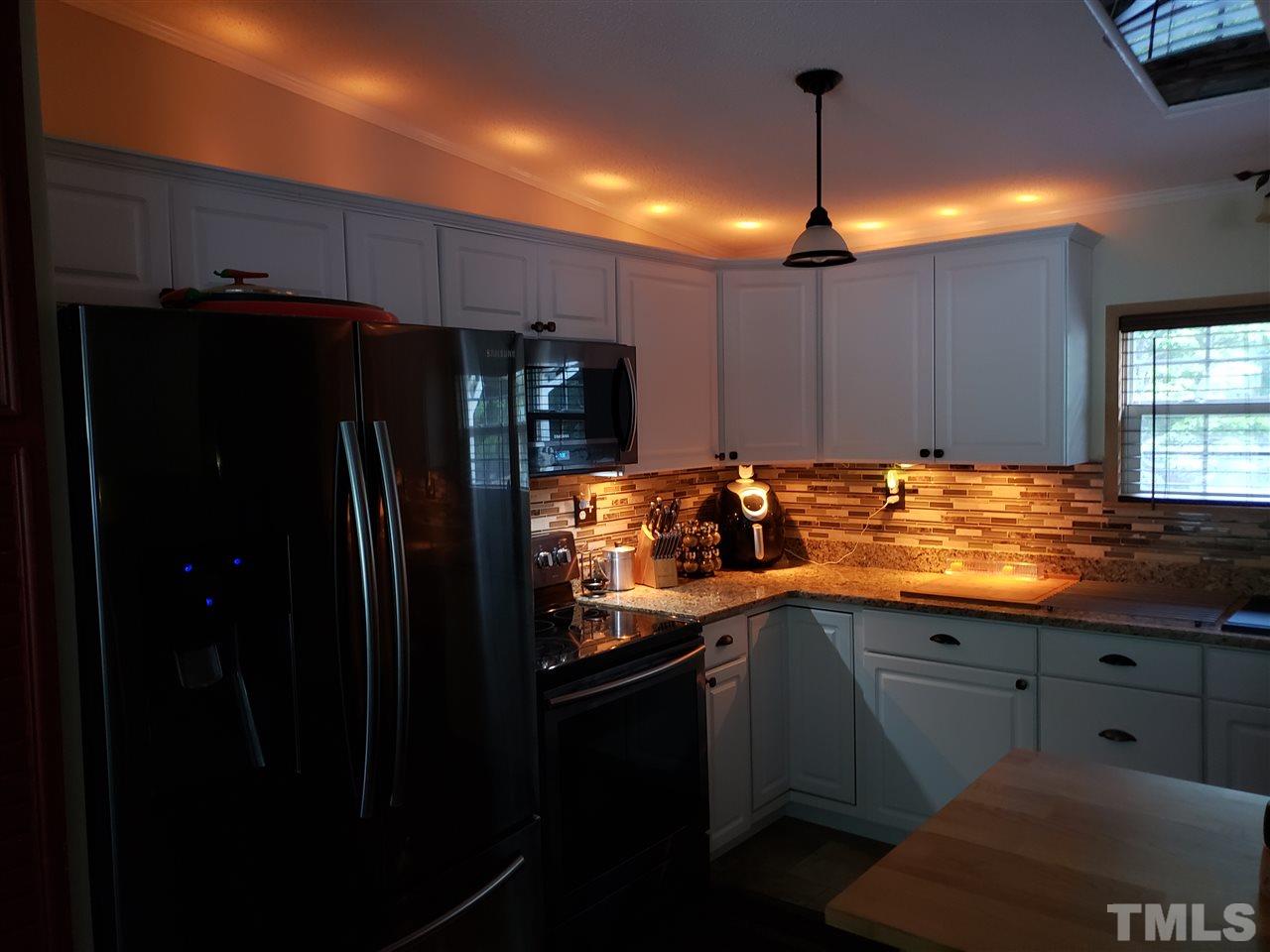 301 Mountain Ridge Road Rougemont, NC 27572 - Photo 19 of 22 a kitchen with stainless steel appliances granite countertop a refrigerator and a sink