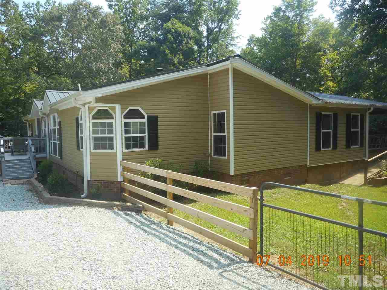 301 Mountain Ridge Road Rougemont, NC 27572 - Photo 3 of 22 a front view of a house with a yard