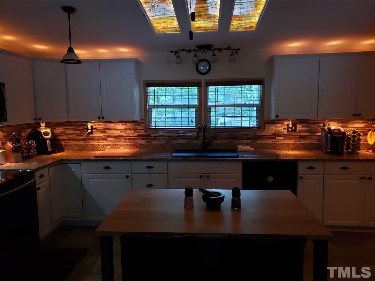 301 Mountain Ridge Road Rougemont, NC 27572 - Photo 22 of 22 a kitchen with a sink a counter space cabinets and appliances